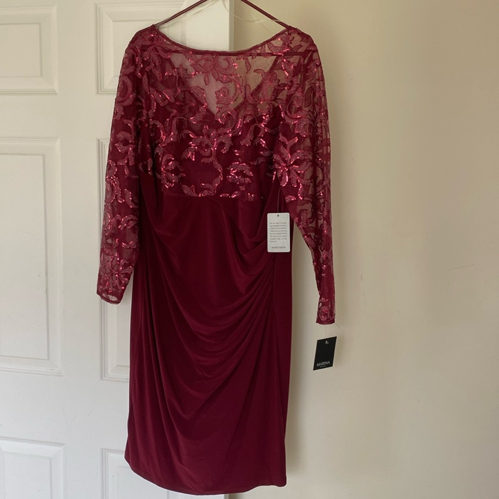Wine colored formal dress. Knee length with a zippered back.